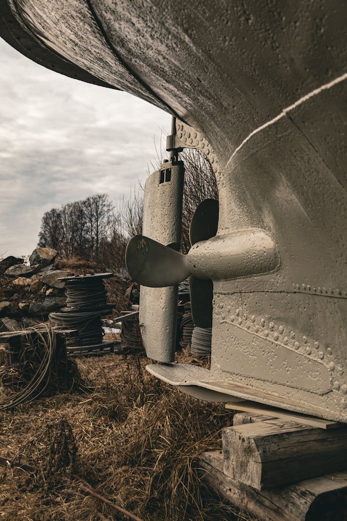 Close-up of a ship propeller in a scrapyard, showcasing industrial textures and rustic ambiance.
